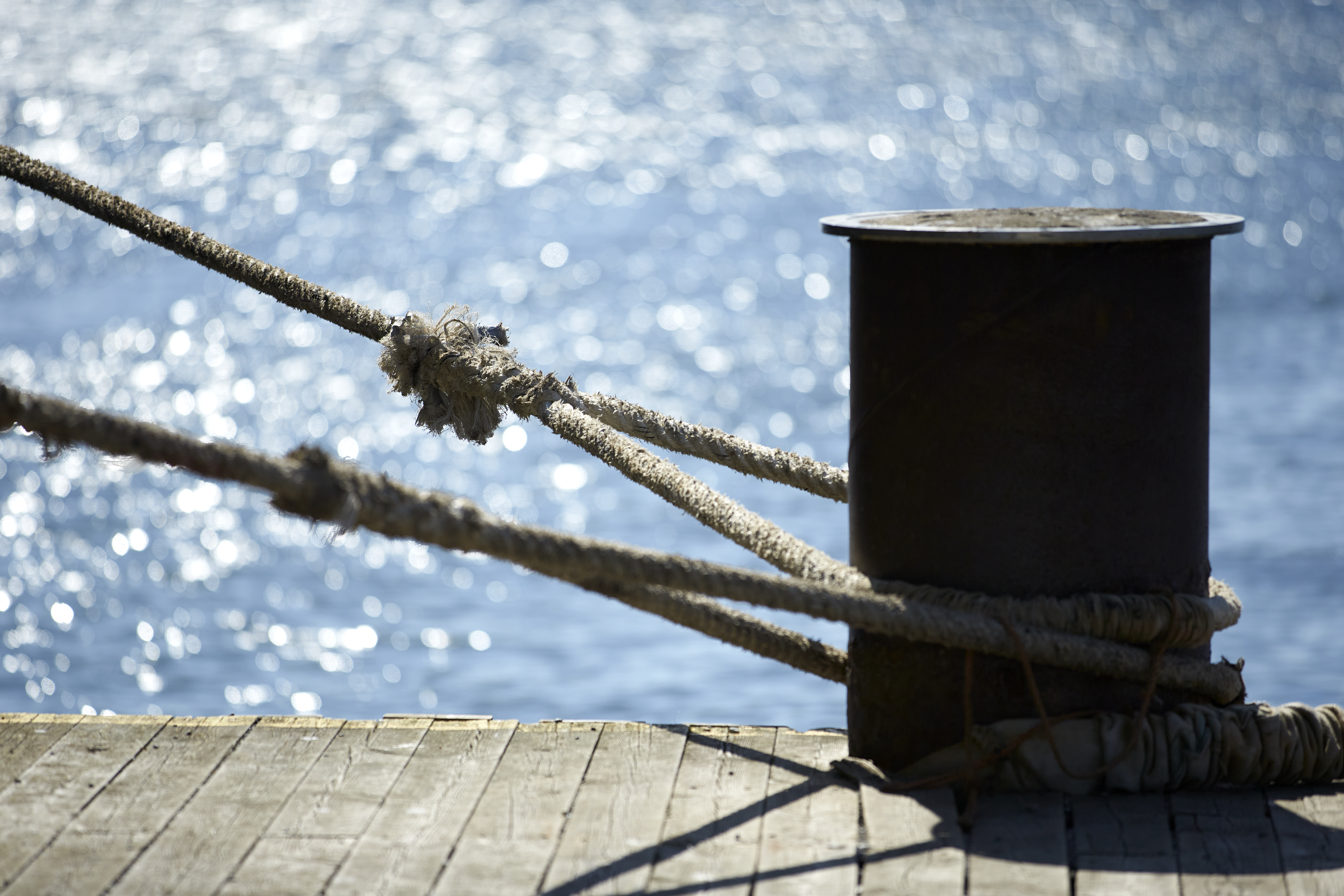 Tied rope around mooring pole in the port of Gothenburg